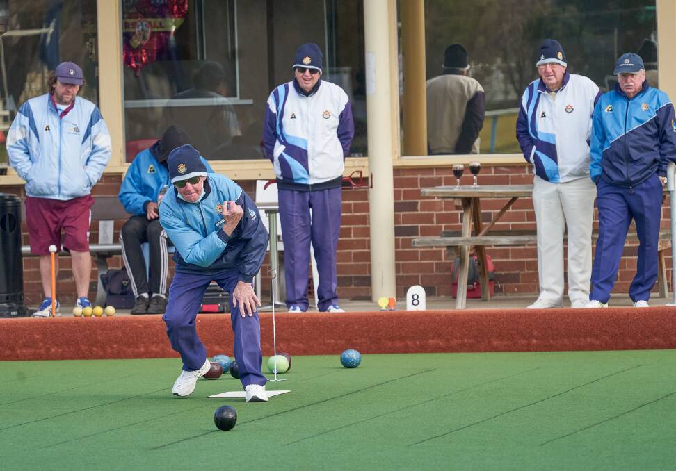 Brian Porter bowls with one onlooker braving the cold! Photo: Robin Staples