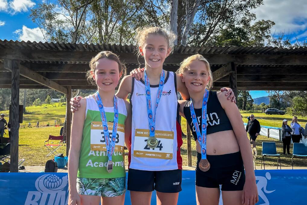 Pixie Hanson (centre) was crowned State Champion when she won the NSW Under 12 three km event at the Athletics NSW Cross County Championships. Photo: supplied