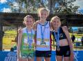 Pixie Hanson (centre) was crowned State Champion when she won the NSW Under 12 three km event at the Athletics NSW Cross County Championships. Photo: supplied