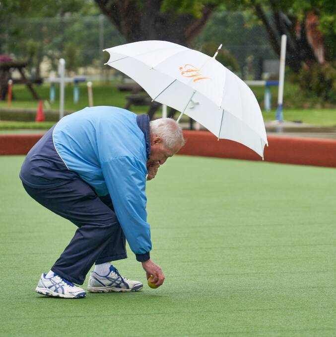 Graham Hunt tries to stay dry during the match. Picture: Robin Staples