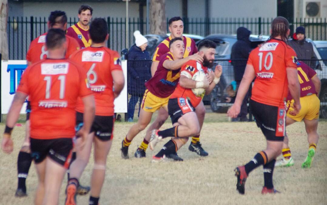 A Tigers player attempts to gain some valuable metres. Photo: Mike Shean