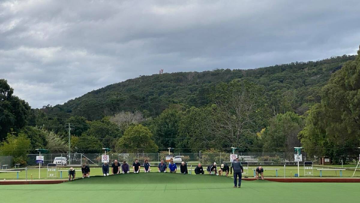Volunteers and Bowral Bowling Club members helped restore the green on Saturday. Picture: Bowral Bowling Club Facebook