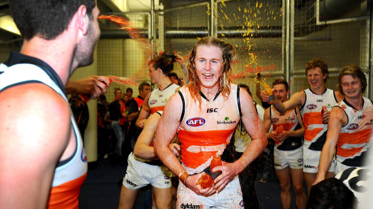 Cam McCarthy celebrates with team mates after GWS' first ever win on August 31, 2014. Picture AAP Image/Joe Castro