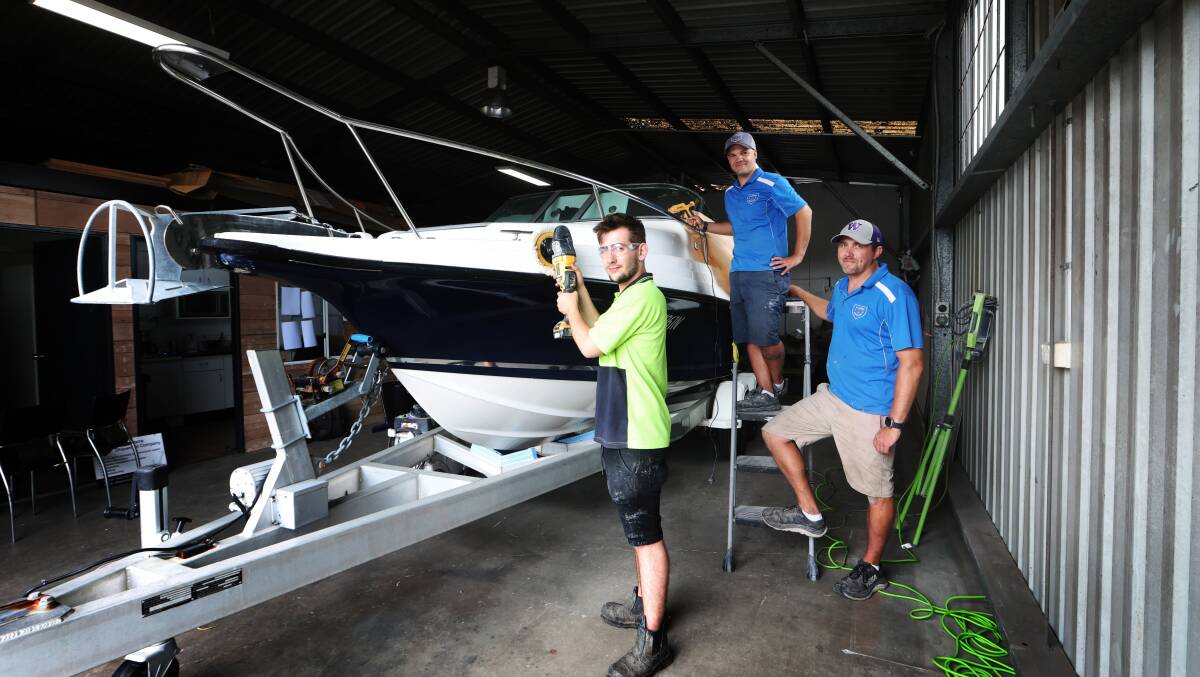 Illawarra Shipwright Company employee Angus Duncan with business partners Fredrik Andreason and Sam Kennady at their Unanderra business. Picture by Sylvia Liber