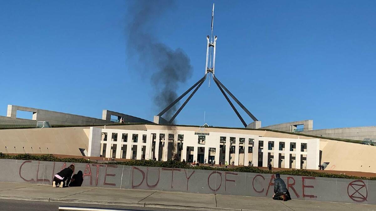 "Climate duty of care" has been painted outside Parliament House. Picture: Supplied
