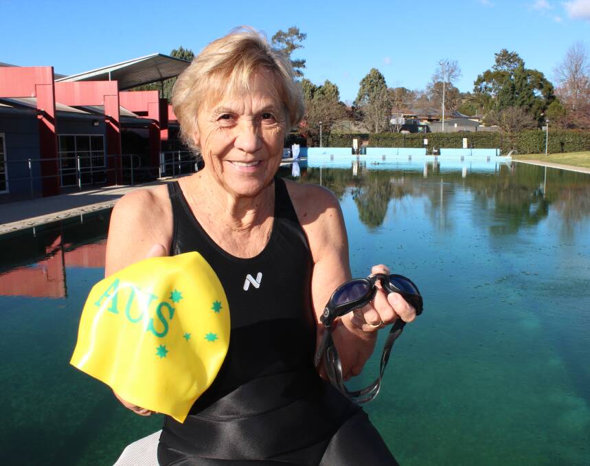 DELIGHTED: Picton swimmer Annie Cook holds up her Australian cap. Picture: Joshua Bartlett