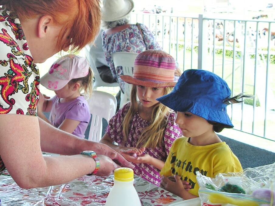 Mittagong pre-schoolers make brightly coloured felt balls with the guidance of Suzi from the Southern Highlands Yarn Spinners Group. Photo: Supplied.