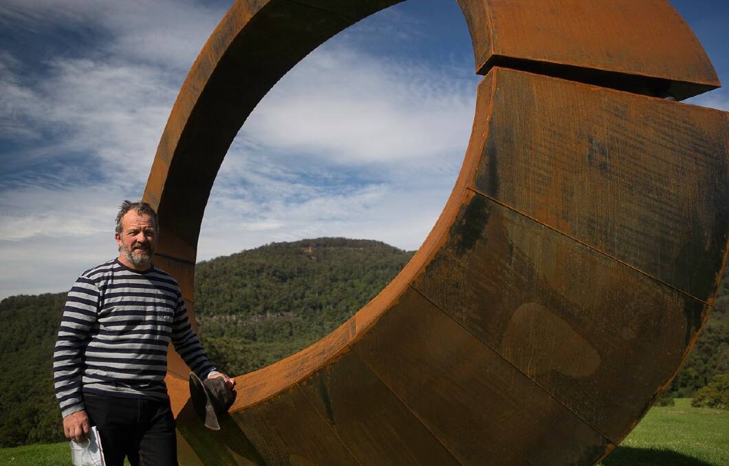 David Ball stands next to his winning sculpture, 'Orb' that was awarded the $60,000 Sculptures by the Sea prize. Photo: Mark Goodwin. 