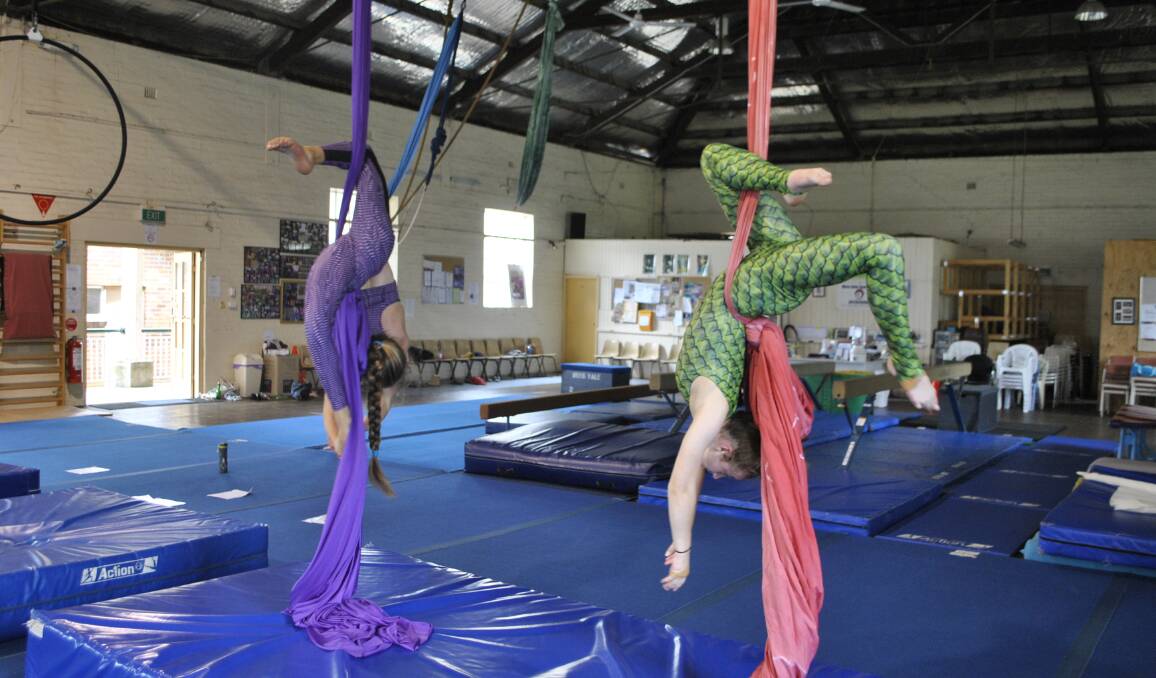 AIRBORNE: Two of the 20 aerial gymnasts that will fly through the air at this weekend's end-of-year showcase for the Moss Vale Aerial Silks. Photo: Charli Shield. 