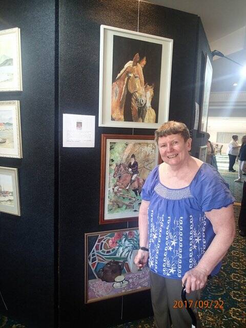 Resident Coralie Walker stands next to her work, on display at Bowral House. Photo: supplied. 