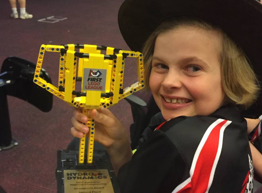 ROBOTICS: Glenquarry Public School Year 3 student Cara Sims holds her team's trophy from the First Lego League's robotics competition. Photo: Supplied.