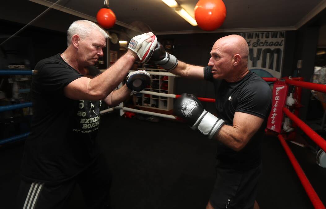 Hitting the pads: Boxing trainer Lee Carr keeps Paul Crampton in top shape at Downtown Old School Gym in Crown St, Wollongong.