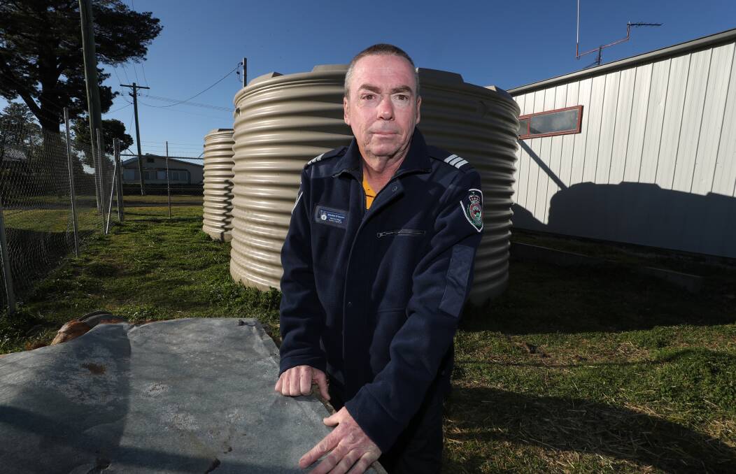 Balmoral Village Rural Fire Brigade captain Brendon O'Connor in front of water storage tanks at the station that will hopefully be upgraded. Picture: Robert Peet