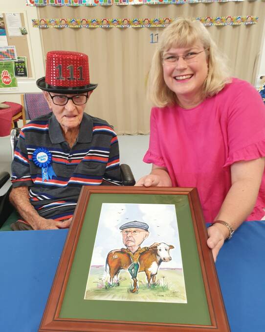 Dexter Kruger shows off one of his 111-year-old mementos to Warrego MP Ann Leahy.