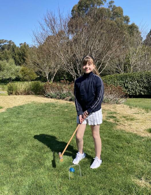 HOME SPORTS: Sophia Denington plays croquet during her breaks or jumps on the trampoline and plays tennis with her dad to keep fit during lockdown. Photo: Supplied
