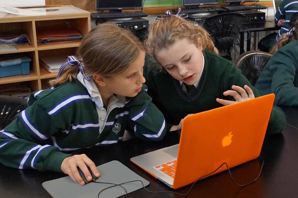 TECHNOLOGY READY: Year 5 students, Alice Mulligan (left) and Sophie Alexander, work on their coding skills