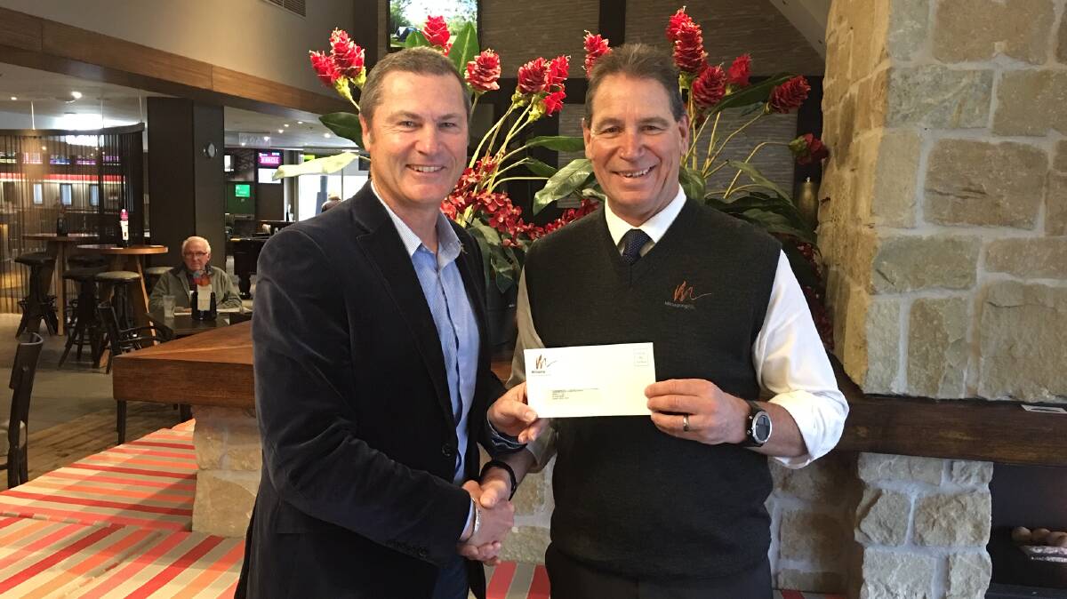 General manager Craig Madsen handing over the cheque to HDCA director Simon Taufel.