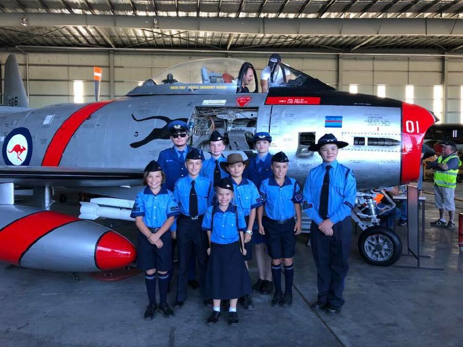 Australian Air League cadets posing in front of an Australian fighter jet.