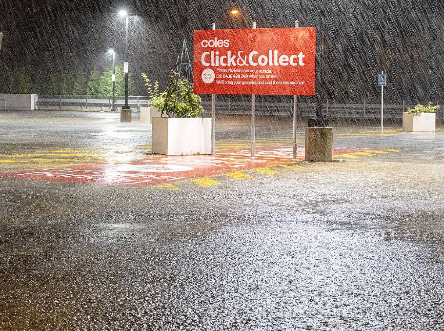 HARD AND HEAVY: Rain fall over the Bowral Coles car park. Photo: John Swainston.