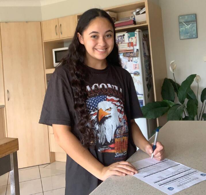 SIGNED, SEALED, DELIVERED: Southern Highlands upcoming soccer star, Georgie Lewis signing her contract with American college Indian Hills. Photo supplied. 