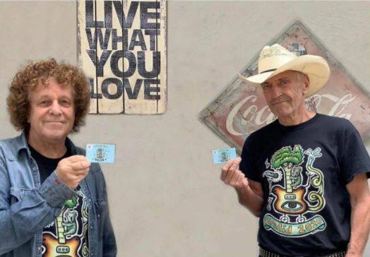 Leo Sayer and John Waters with the reloadable FireAid cards. Photo supplied