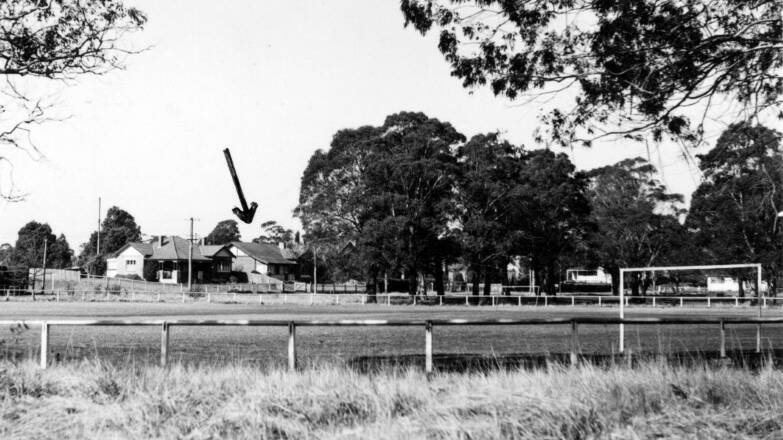 HANDY LOCATION: A 1960s view over Bowral's Bradman Oval to the Bradman family home (arrowed) on Glebe St, built by Don's father George in 1924 facing what was then Glebe Oval. Photo: BDH&FHS