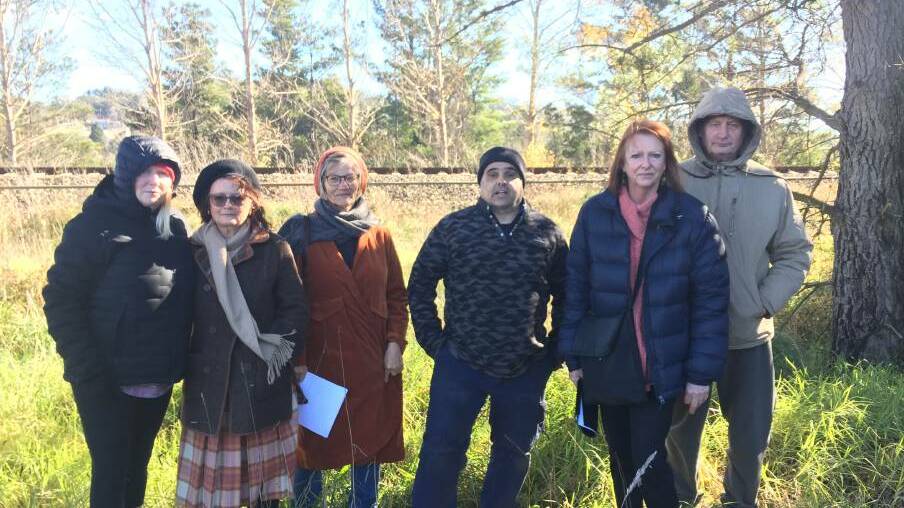  Laurence Bourrigard, Myrtle Kafka, Chris Hurditch, Stephane Bourrigaud and Joanne and Ron Rosendale stand across from their properties and in front of the railway line at Railway Parade. The Bowral Waste Centre is directly behind the trees. Photo: Michelle Haines Thomas