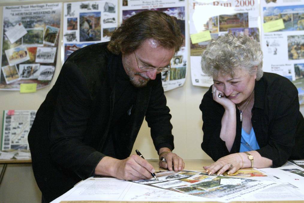  THE ARTIST: Ulf Kaiser signs posters with Leonie Knapman at 2003 Mittagong Heritage Weekend. Photos: BDH&FHS