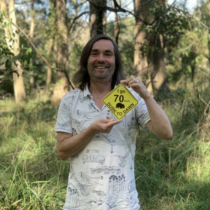 Andy Carnahan with the swing tag he created. Photo supplied
