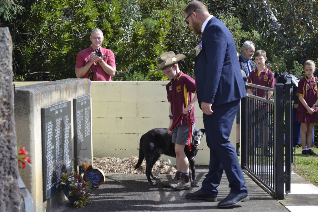 Lance Corporal Rueben Griggs is joined by his son Henry and Explosive Protection Dog to lay a wreath at the Robertson memorial. Picture by Jackie Meyers