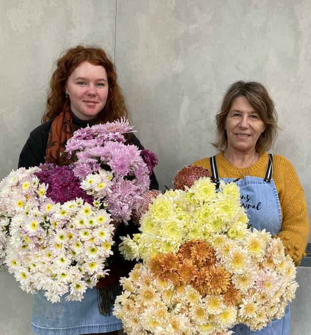 Hannah Goodfellow and Michelle Clayton with a selection of the traditional Mothers' Day flower, Chrysanthemums. Photo supplied