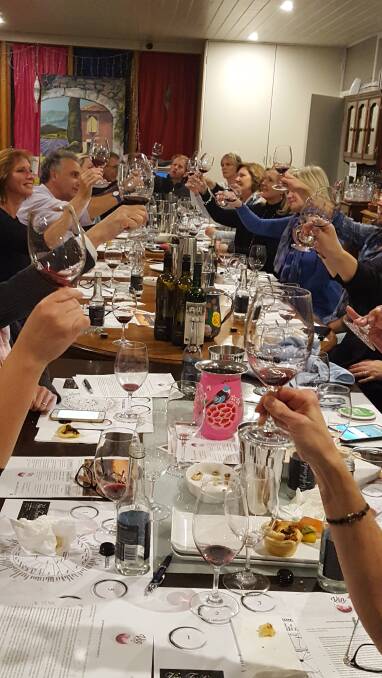 GLASSES RAISED:  There's lots of fun to be had while learning about the fine art of wine tasting.