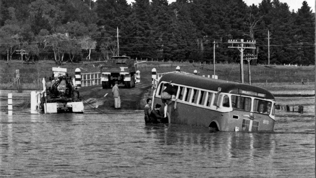 DISASTER AVERTED: At Bong Bong Bridge on July 22, 1959, getting ready to pull the stranded bus out of floodwater. Photo: BDH&FHS
