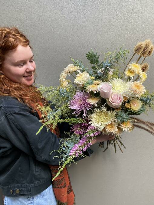 Florist Hannah Goodfellow with an arrangement of flowers for Mothers' Day. Photo supplied
