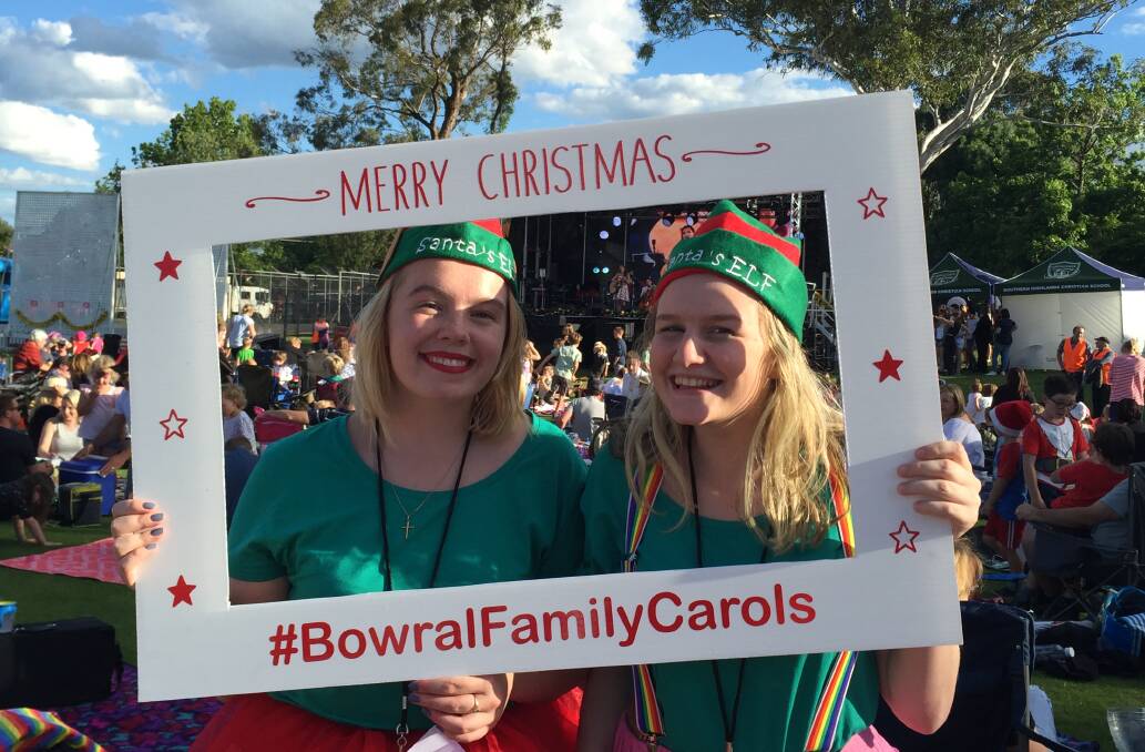FESTIVE SPIRIT: Bethany Herford and Lilli Hessenberger made sure they were in the picture at the 2017 Bowral Family Carols at Bradman Oval. Photo: Jackie Meyers