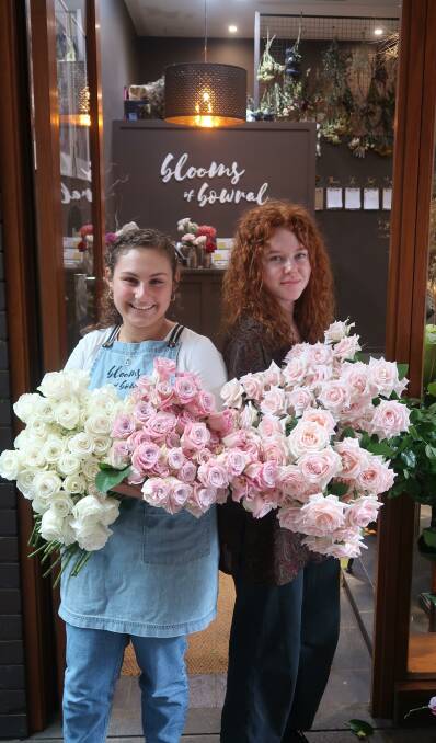 In full bloom: Malisa Hassos and Hannah Goodfellow from Blooms of Bowral are ready to help you on Valentine's Day. Photo: Vera Demertzis