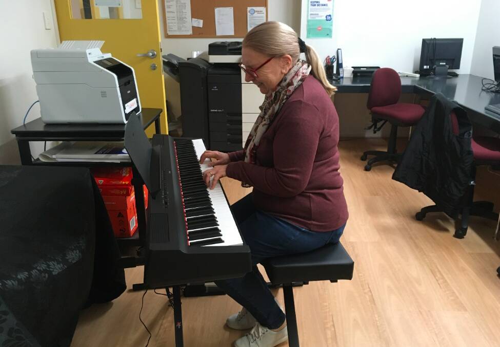 Jenny Kena, CTC Robertson President tickles the ivories on the new piano. Photo: supplied. 