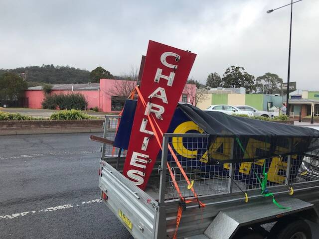End of an Era: The iconic neon Charlie's Cafe sign was removed overnight on August 30 and spotted partially covered by a tarp. Photo: Peter Griffiths.