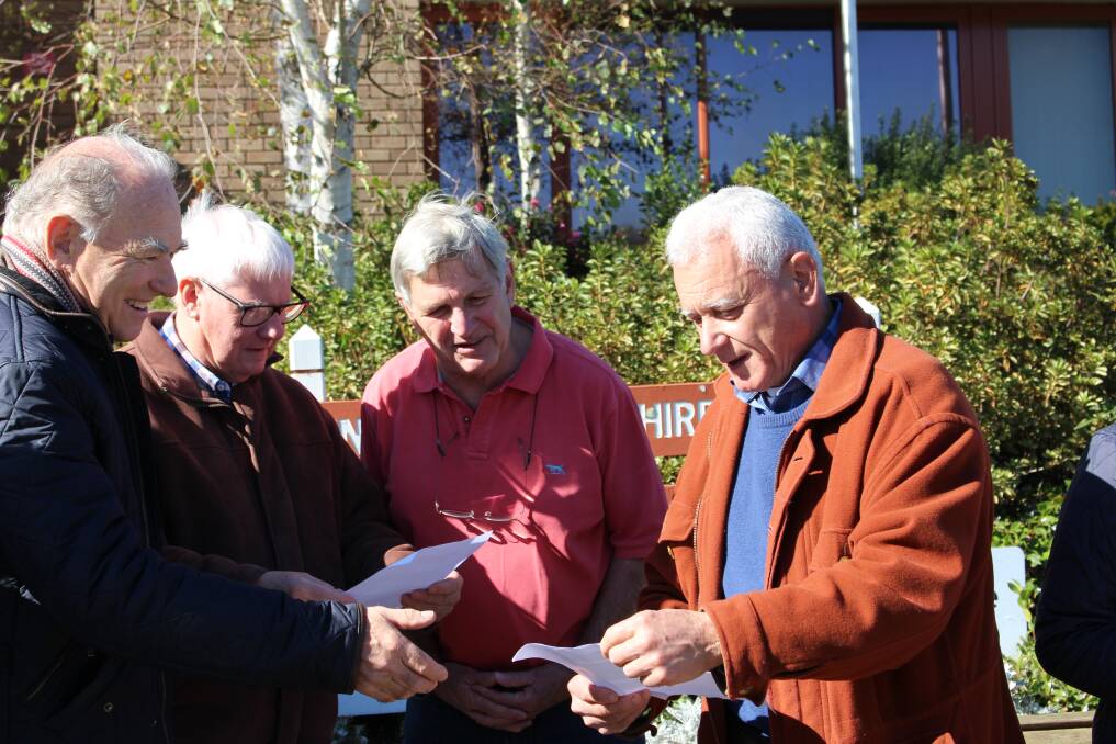 Clive West (far right) handing out petitions in front of council. Photo: Vera Demertzis