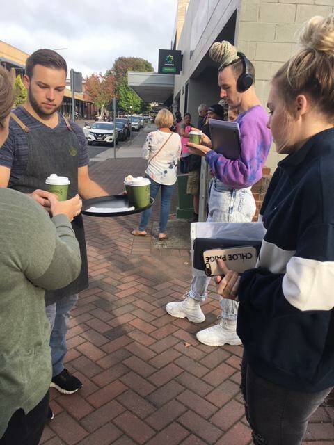 Takeaway: Staff from Janeks Cafe took business to the customers as they waited in line. Photo: supplied.