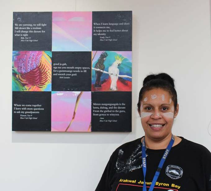 NAIDOC Week: Aboriginal community development officer Melissa Wiya stands in front the poetry created by students in the Gundungurra language at the 2019 NAIDOC Week. Photo: file