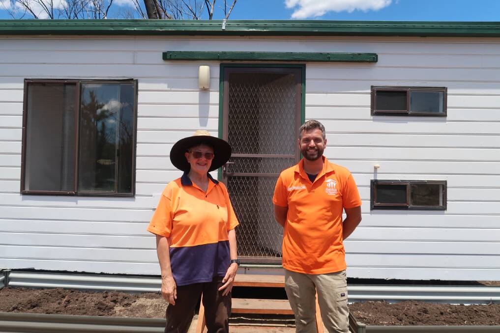 Out of the ashes: Elizabeth and Tom stand in front of Elizabeth's temporary home. The Green Wattle Creek which devastated Balmoral Village destroyed Elizabeth's home. 