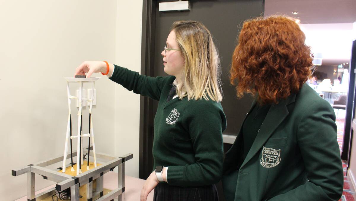 Two students from Southern Highlands Christian School test their structure against an Earthquake simulator. Photo: Vera Demertzis.