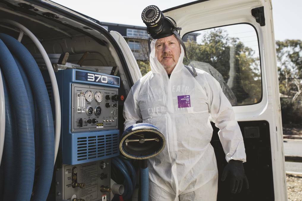 FORENSIC CLEANER: Bryan Norris in PPE gear. Photo: The Canberra Times