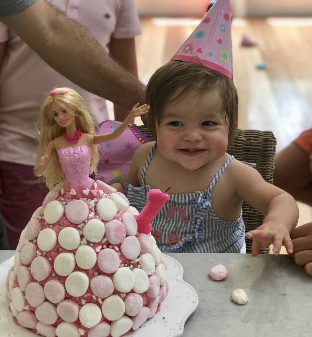 Audrey was definitely pleased with her special Barbie cake and was excited to see how it tasted. Photo: supplied