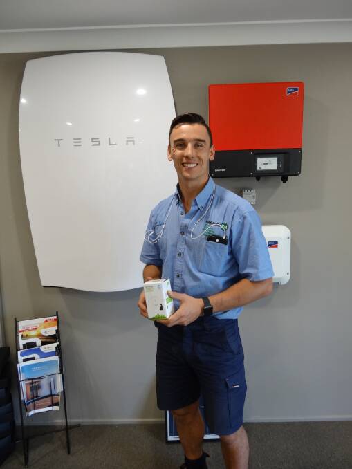 Matthew Simms from Simmark with a Tesla Energy Powerwall. Photo supplied