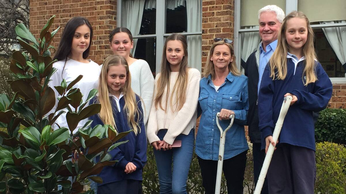 SCHOOL SPIRIT: Lauren, Molly, Maddison, Brooke, Dinah, John and Lily Kable planting the tree at the school. Photo: supplied
