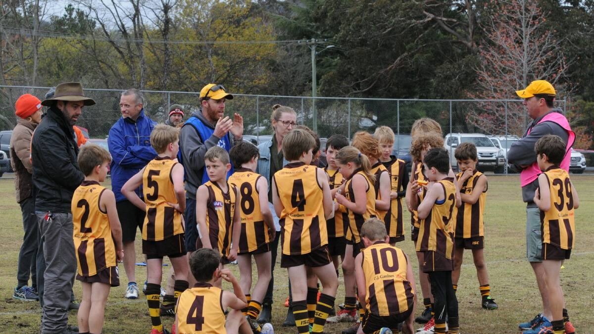CONTINUED IMPROVEMENT: Hawks under-11 coach Matt Griffiths gives his team a pep talk during a home game earlier in the season.