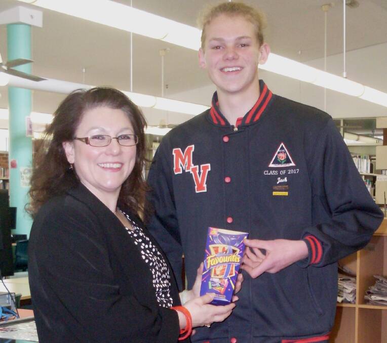 Moss Vale High Librarian Kathryn Cripps presents Josh Huggett with his Vivo prize. Photo supplied