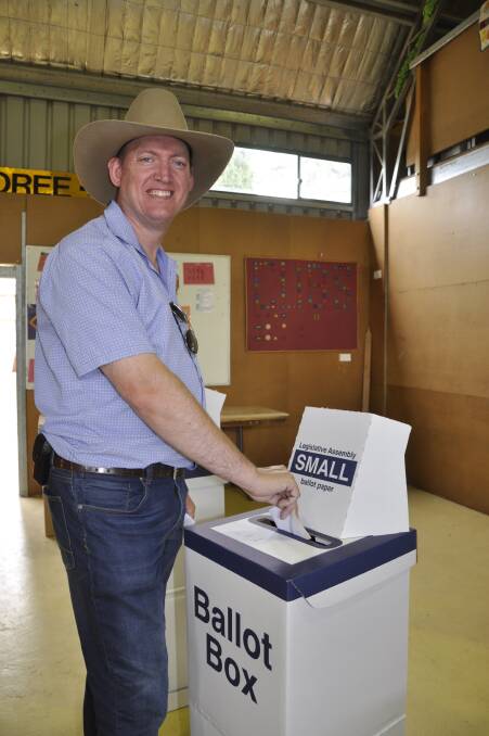 Shooters, Fishers and Farmers candidate Andy Wood casts his vote at Goulburn's Scout Hall on Saturday. Photo: Louise Thrower.